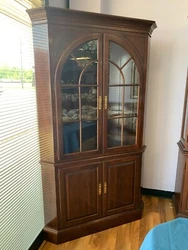 This is a beautiful Ethan Allen wooden corner china cabinet. This china cabinet is triangular shape to fit in any...