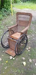 It is in beautiful condition for the age. It is brown wood and wicker. There is a stamp plate on the back bottom marked...