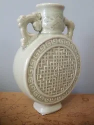 Jade green celadon Asian pottery. Circular canteen moon shaped and waffle textured body with ornate duel handles....