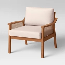 •Beige lounge chair makes a versatile addition to your home •Made with a wooden frame in brown hues •Cane back...