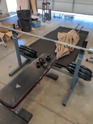 bench press bar with weights and rack. Over 300 lbs of weights 