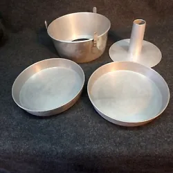 This pan has the lift out center section. Is made of Aluminum. These have markings on the underside that read;. These...