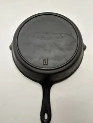 This is a vintage unmarked No. 7 cast iron skillet with a heat ring and gate mark. It has the small pour spouts and a...