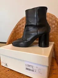 Classic black leather ankle boot by Maison Margiela with zipper closure and round, blocked heel. Includes box.