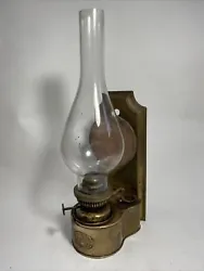 An original brass and copper oil lamp for wall mounting hanging The shade just sits on the burner In original as found...