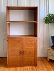 As accent. Teak veneer. (all teak furniture is veneer). Top piece has pull out shelf. Bottom cabinet has two doors and...