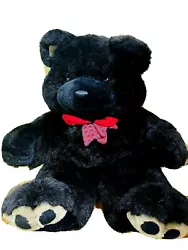 Big beautiful black bear, black eyes & nose. Red with plaid bow. Gray on bottom of feet. they are not, bottoms are gray.