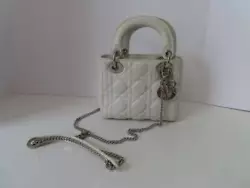 Color: Eggshell Fabric: Cannage Stitched Calfskin Hardware: Silver Metal D.I.O.R. Charms, Removable Chain Shoulder...