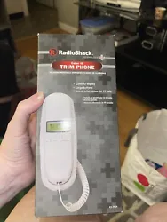 The phone can be mounted on a wall or placed on a desk for convenient use. This model, 43-3904 white, is a trimline...