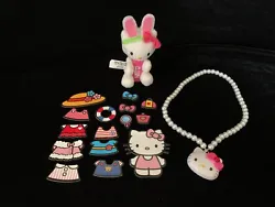 (1) Hello Kitty soft Pez dispenser key chain. (1) Set of 15 Hello Kitty magnets. (1) Set of play pearls with Hello...