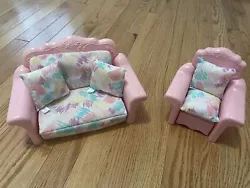 This vintage Barbie furniture set from 1987 includes a pull-out couch and an armchair, both with bright pink plastic...