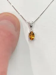 The item is a 14k white gold citrine and diamond pendant. The diamond is round and weighs 0.03 carats. The diamond has...