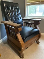 This vintage mission style recliner exudes classic elegance with its black leather upholstery and wooden frame. Crafted...