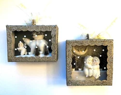 Both have bottle brush trees, and one has a polar bear. Theyre both embellished with lovely tarnished silver glitter...