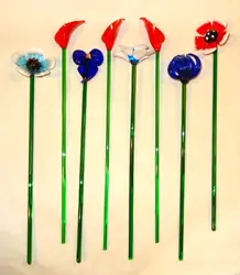 The glass flowers are shaped like red calla lily, blue calla lily, daisy or poppy, water lily or chrysanthemum flower....