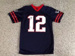 NEW ENGLAND PATRIOTS TOM BRADY FOOTBALL JERSEY IN ROUGH SHAPE WITH LOTS OF GRAPHIC WEAR SIZE TAG IS MISSING BUT...