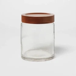 Give your indoor space a neat and clutter-free look with this chic and stylish Acacia/Glass Canister from Threshold™...