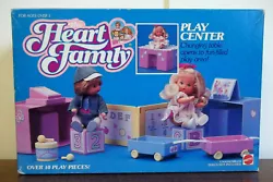 Changing table opens into play area. Heart Family Play Center. changing pad. New, unused in original sealed box. box is...