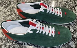Rendered in Guccis two-tone dark-green and red, these panelled suede trainers strike a careful balance between sport...