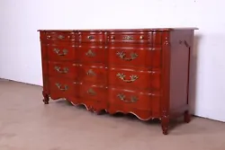 By John Widdicomb. An exceptional French Provincial Louis XV style twelve-drawer dresser or credenza. Newly refinished...