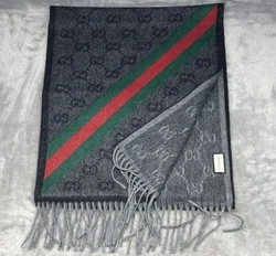 Elevate your winter wardrobe with this luxurious Gucci Monogram GG wool scarf. Made in Italy with a blend of 75% wool...