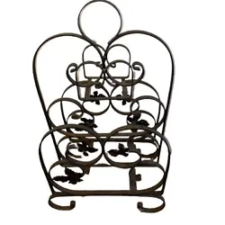 Antique Iron Floral Magazine Rack Black Iron. It measures 12 wide 8” deep 21” tall. It has some very minor surface...