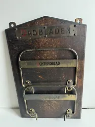 Up for auction is an ANTIQUE DUTCH NEWSPAPER MAGAZINE RACK. Made of wood and metal. WALL MOUNTED. The metal bars lay...