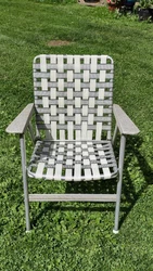 Vintage Folding Lawn Chair Mid Sixtys Original Webbing. Tin Arms with Vinyl covering. Still has Folding Instructions....