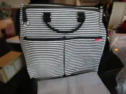 Thickly padded strap and handle in ultradurable synthetic webbing. note bag used for a Pottery Barn photo shoot sample...