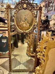 Carved wood with parcel gilt and painted finish, featuring a pastoral scene aligned above the rectangular mirror plate....