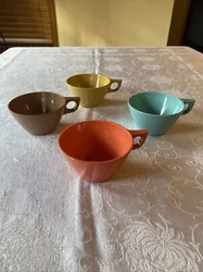 Cute vintage set of 4 tea cups. Each cup is a different color; but they coordinate together and look great. No saucers....