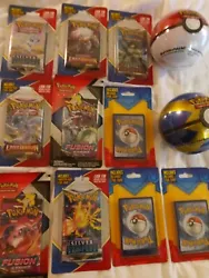 pokemon lot sealed packs and two pokemon balls with cards inside.