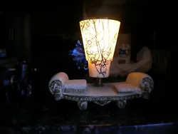 Art deco lamp on a Victorian couch. super cool ….