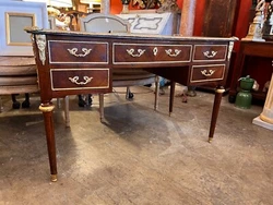Neoclassical clean lines, strong contrast between flaming mahogany and newly regilded bronze and brass appliqués and...