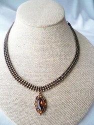 Vintage signed 1928 Co. Amber Rhinestone pendant 3 row brass ball chain collar necklace. Pendant measures 1