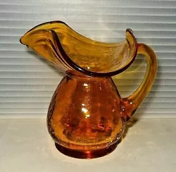 You are buying a gorgeous Mid Century hand blown gold crackle glass pitcher vase with a flared opeing. This piece is in...