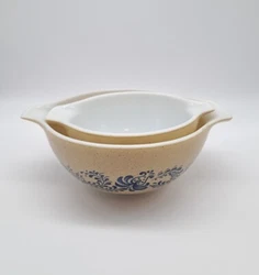 Pyrex Mixing Bowls in with tan speckles and a blue flower design, a vintage set made in the United States. The bowls...