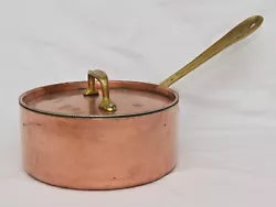 It is in great condition. The interior is clean. Handles are brass. The pot is made with a copper exterior, aluminum...