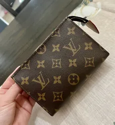This Louis Vuitton Monogram Toiletry Pouch 15 is a stylish and practical accessory for both men and women. Crafted from...