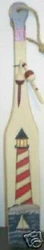 This nautical boat oar features a picture of a red and white stripped Lighthouse with an ocean scene below.There two...