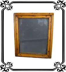 An antique and authentic French mirror from Louis XVI period, 18th century. The wooden frame features a fine decor of...