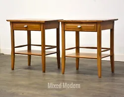 A pair of mid century modern solid maple single drawer nightstands made by Heywood Wakefield. Aluminum hardware.