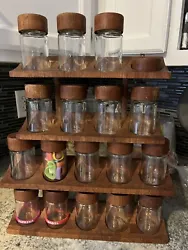 1 rack holds 8 jars missing 1 jar that broke have teak lid. Both are wall mount or counter spice racks.
