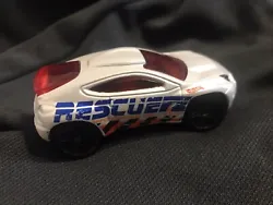 This Hot Wheels diecast toy features a white 2001 Toyota C-HR Police SUV from the Rescue series. The vehicle is made of...