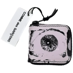 Made of pink genuine leather with allover eye print. Length: 2.5