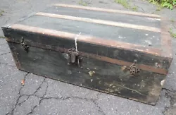 Canvas on wood with iron edges and cast iron hardware. This trunk is begging to be stripped of its canvas and fixed up....