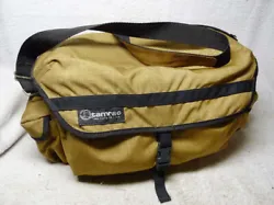 Gold/Tan/Khaki in color. In any event, its made of a canvas material, with padded parts, velcro closures, a zippered...