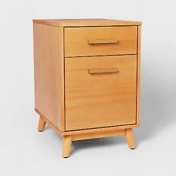 •Mid-century modern file cabinet in light brown •Includes two drawers with handles •Comes with four slatted legs...