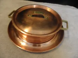 Vintage copper casserole pan with lid and matching underplate.  plate has a channel into which the pan fits...