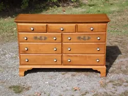 A high quality solid Maple long dresser with 9 dovetailed drawers, stenciling, and Eagle brass/porcelain hardware....